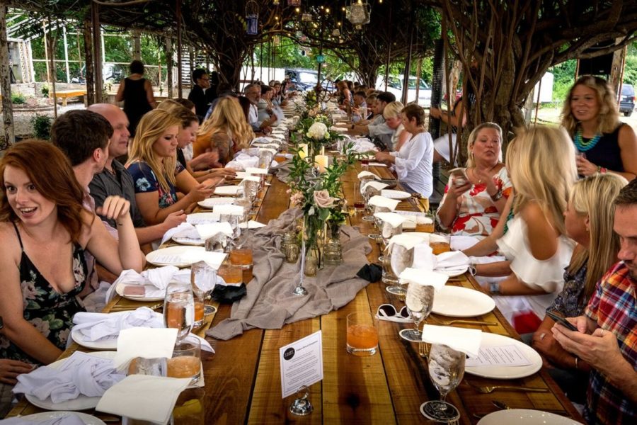 A Group of people dining at 3rd Turn at a communal table during event